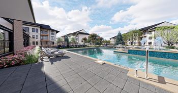A swimming pool surrounded by apartment buildings. at The Logan Luxury Apartments, Nampa, ID, 83651
